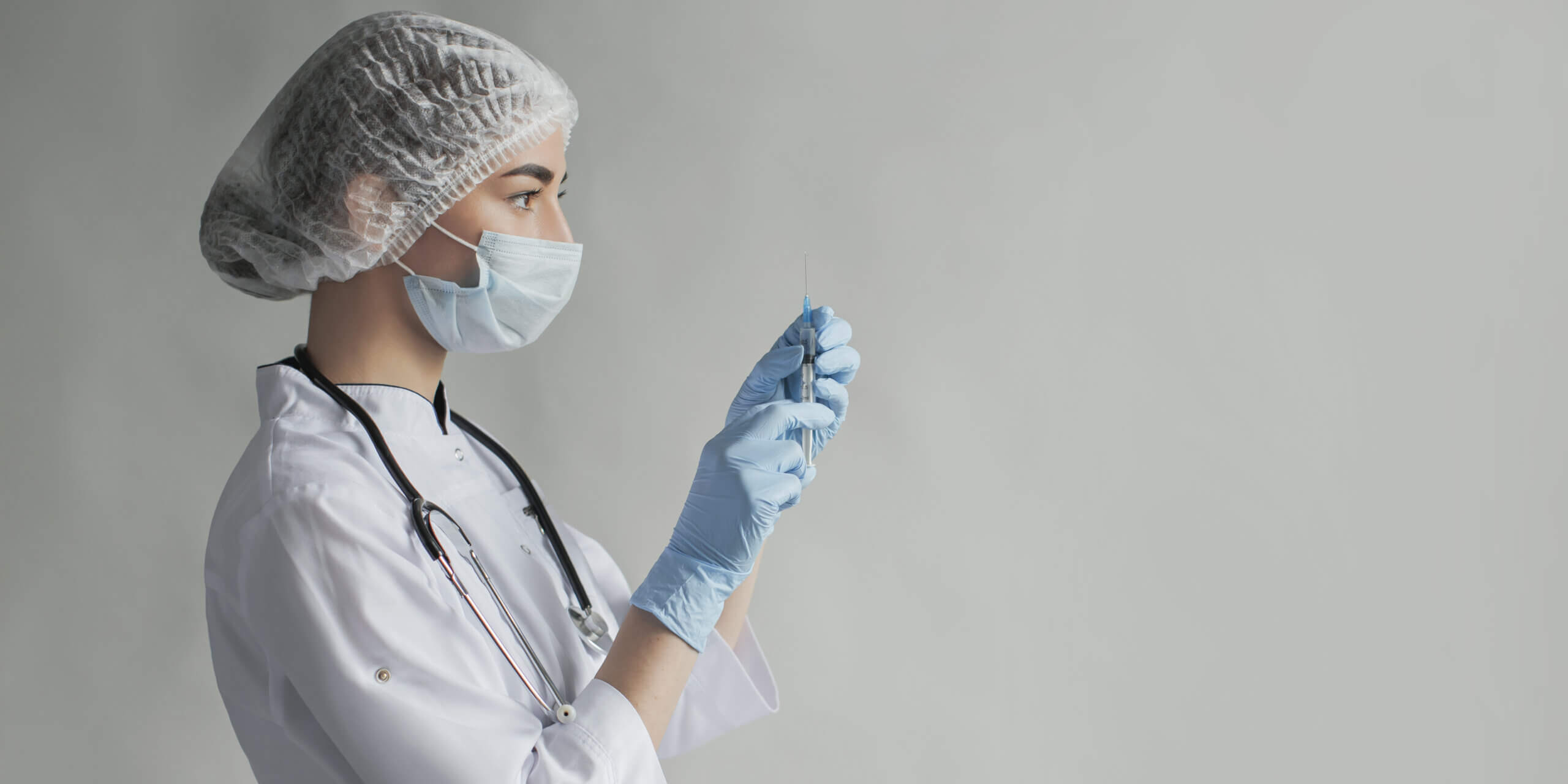 doctor prepping covid vaccine