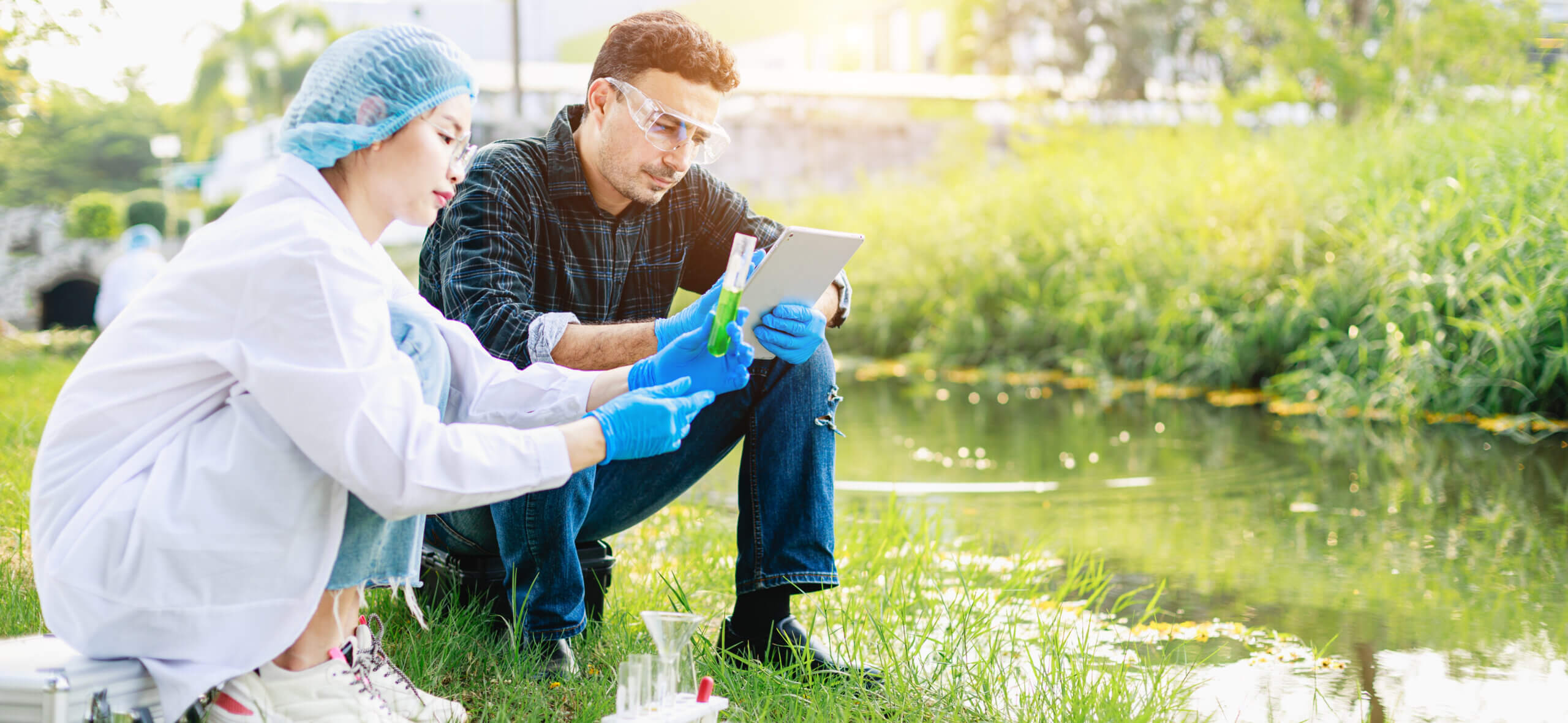 Scientists biologists analyze sample water at an industrial estate. Environment issues