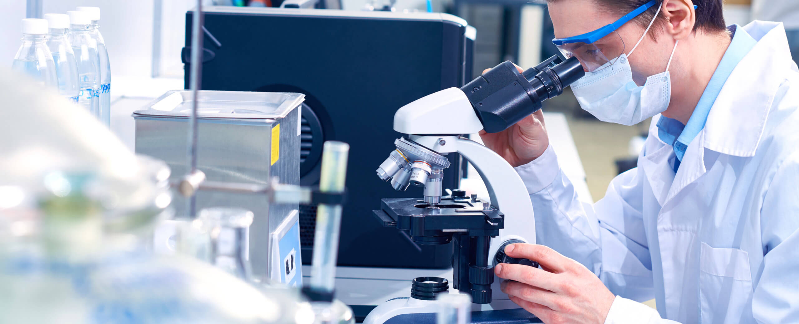 Scientist looking through a microscope in a laboratory