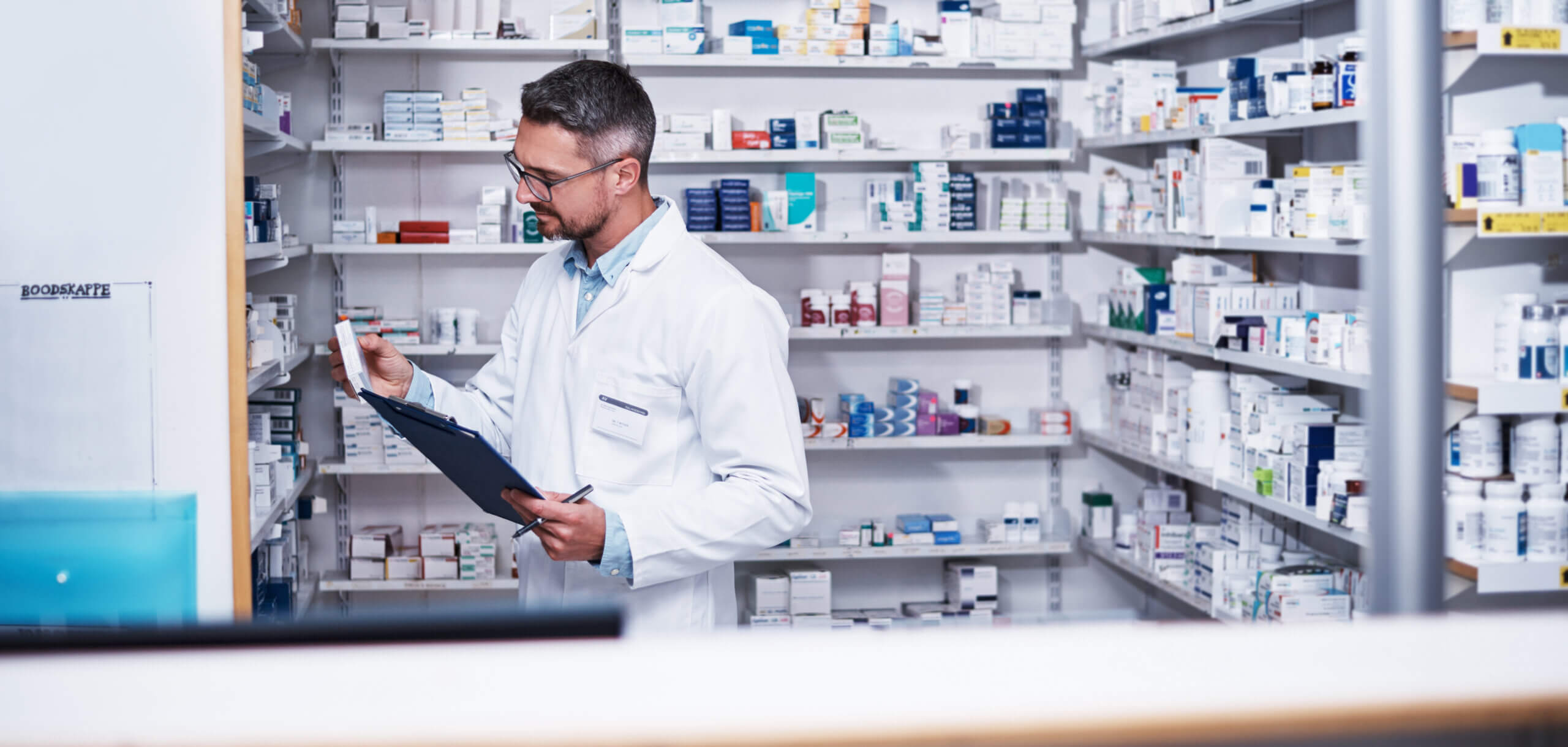pharmacist reviewing inventory.