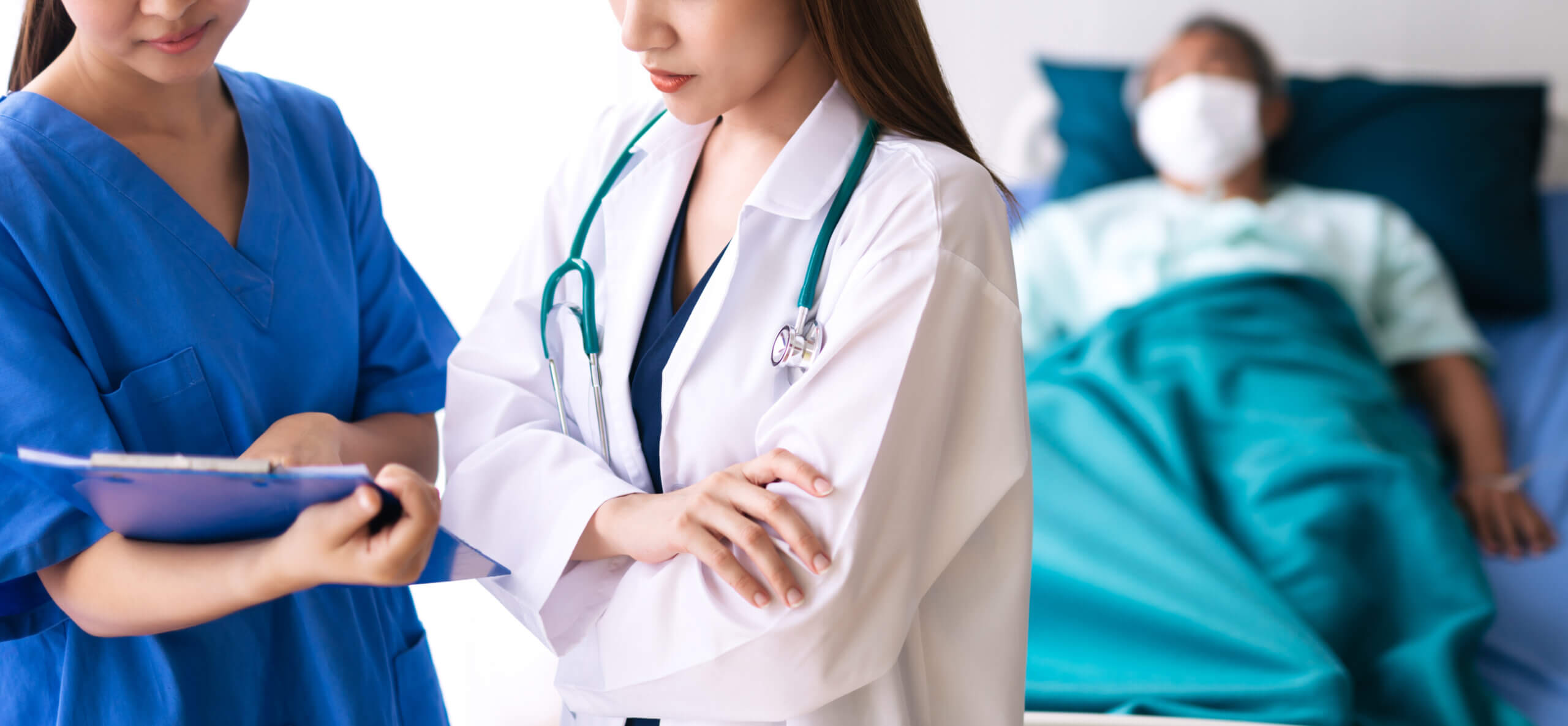 Doctor discussing diagnosis while patient waits.